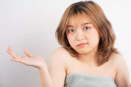 Beautiful xing woman with fresh skin smiling on backgroundの写真素材