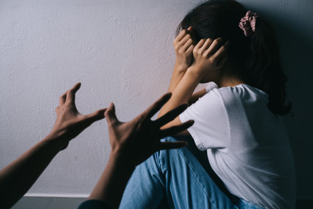 Asian woman hugging her face and crying because of her boyfriend's violenceの写真素材