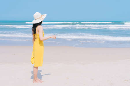 Young Asian woman enjoying summer vacation on the beachの写真素材