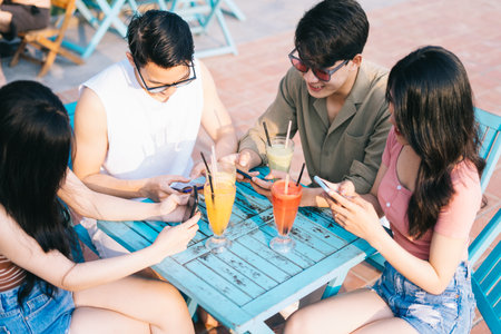 A group of young Asians enjoy a trip to the sea on a summer vacationの写真素材