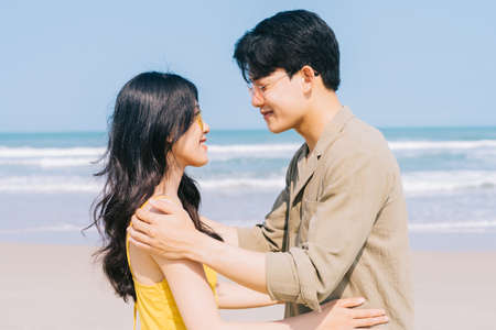 Young Asian couple enjoying summer vacation on the beach