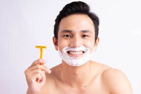 Portrait of asian man shavingの写真素材