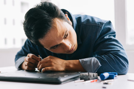 The Asian man was taking out a broken computer to repair it