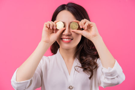 Asian businesswoman holding bitcoin in her handの写真素材