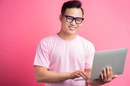 Asian man is using a laptop