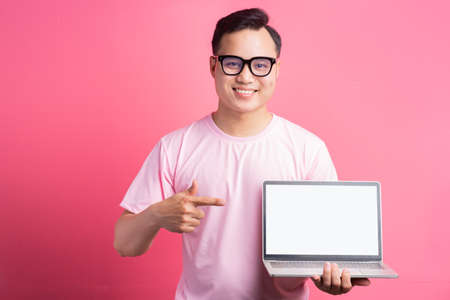 The Asian man was pointing at the computer screen