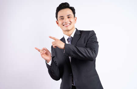 Image of young Asian businessman wearing suit on white backgroundの写真素材