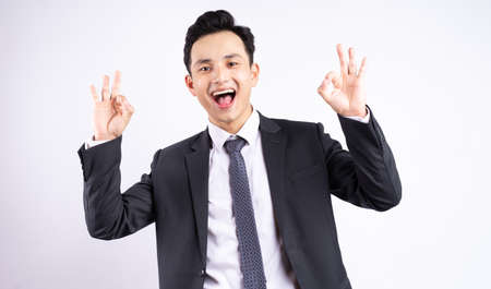 Image of young Asian businessman wearing suit on white backgroundの写真素材