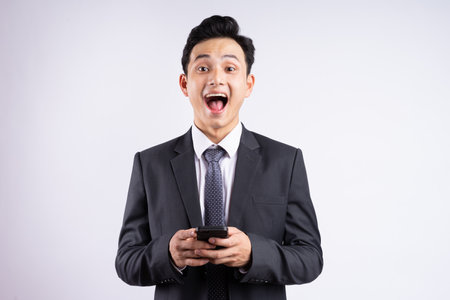 Image of young Asian businessman wearing suit on white backgroundの写真素材