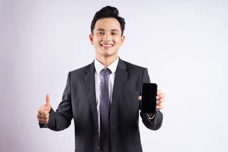 Image of young Asian businessman wearing suit on white backgroundの写真素材