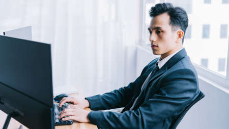 Asian business people are focused on workingの写真素材