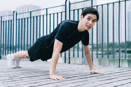 Young Asian man exercising in parkの写真素材