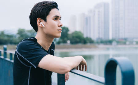 Young Asian man is resting after the practice session