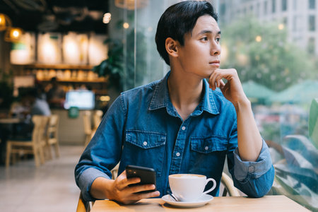 Asian man working at cafe on weekendの写真素材
