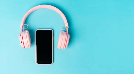 Pink phone and headphones on a blue background