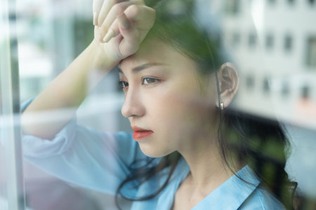 Asian businesswoman feels tired due to pressure from workの写真素材