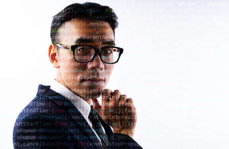 Portrait of Asian businessman with lines of code on his face. Concept of human being digitized in...