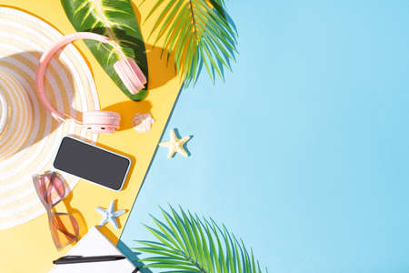 Summer background with phone, headphone, hat and sunglassesの写真素材