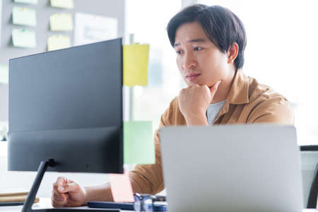 Asian business man working with laptop in officeの写真素材