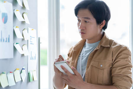 Portrait of Asian businessman standing with arms crossedの写真素材