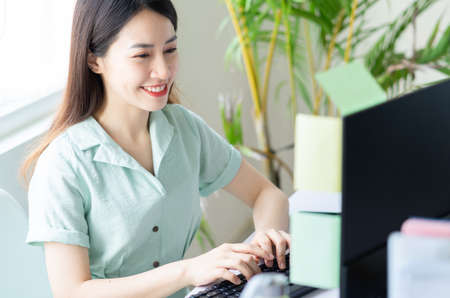 Young Asian woman posing on purple backgroundの写真素材