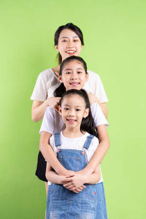 Portrait of Asian family on green backgroundの写真素材