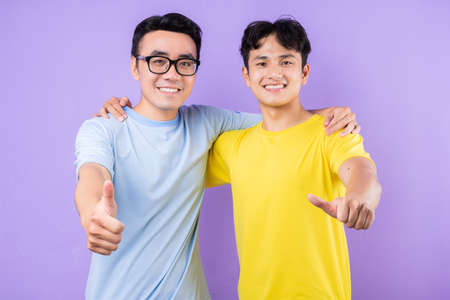 Two Asian brothers arguing with each otherの写真素材