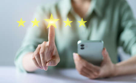 Asian woman rating five stars conceptの写真素材