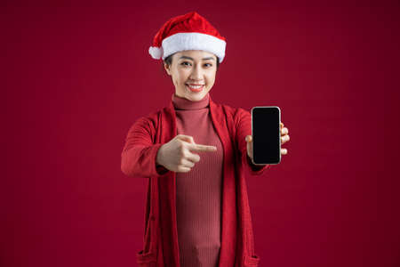 Young Asian woman wearing bathrobe on blue background