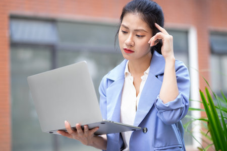 Young Asian woman working outsideの写真素材