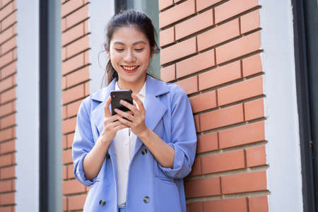 Young Asian woman drinking tea in the gardenの写真素材