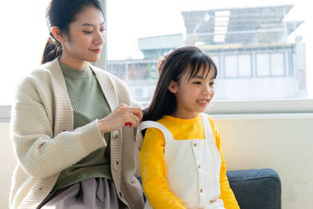 Asian Mother and daughter studying together at homeの写真素材