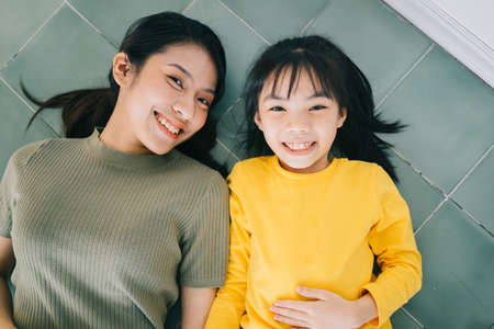Portrait of Asian mother and daughter at homeの写真素材