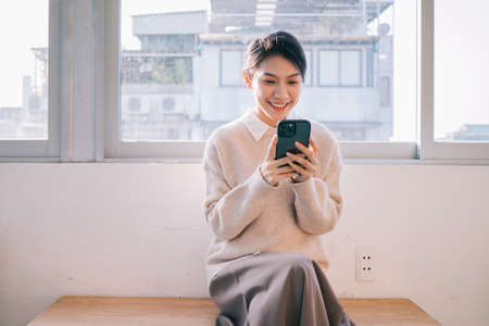 Portrait of young Asian woman relaxing at homeの写真素材