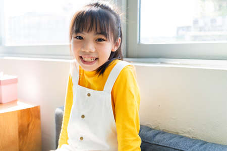 Asian child using smartphone at homeの写真素材