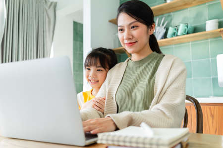Mother and daughter relaxing at homeの写真素材