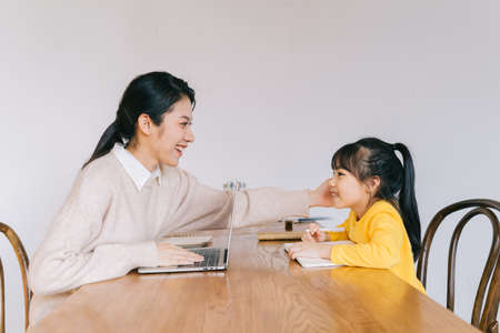 Mother and daughter relaxing at homeの写真素材
