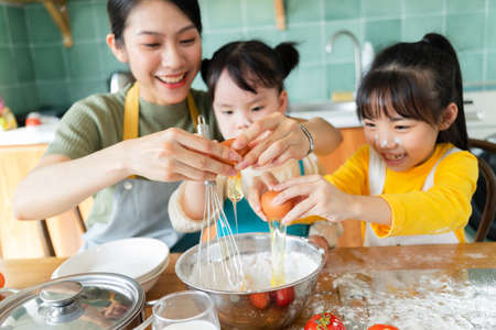 Mother and daughter make cakes together.