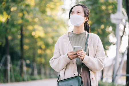 Asian woman driving a motorbike on her way to workの写真素材