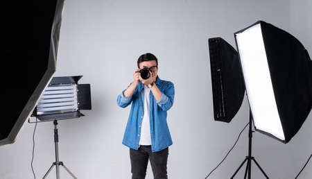 Young Asian photographer checking his photo