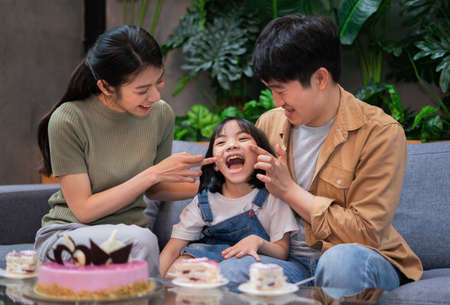 Young Asian couple celebrates their daughter's birthday