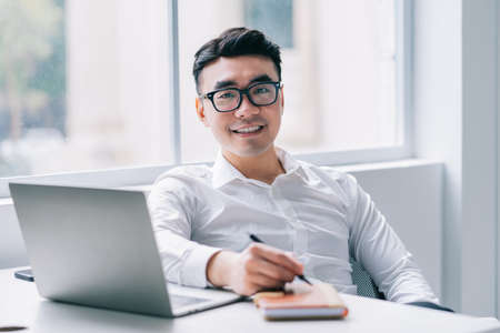Image of young Asian doctor working at clinic
