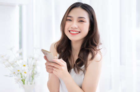 Young Asian businesswoman working and playing with catの写真素材