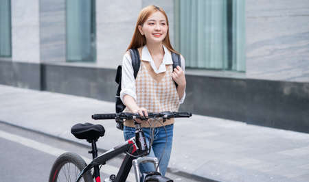 Young Asian woman using smartphone on streetの写真素材