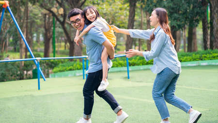 Image of young Asian family playing together at parkの写真素材