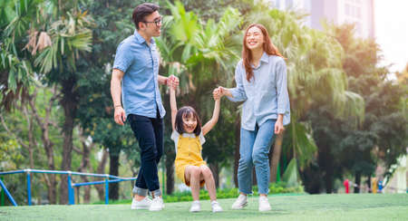 Image of young Asian family playing together at parkの写真素材