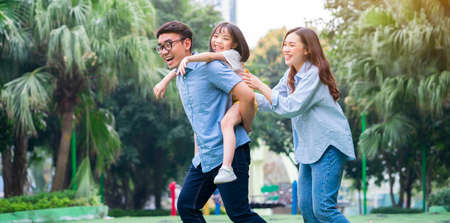 Image of young Asian family playing together at parkの写真素材