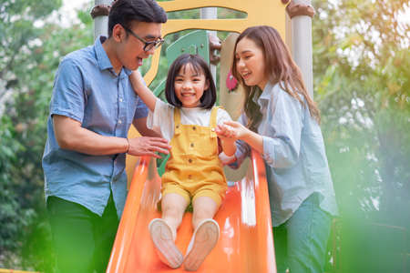 Portrait of young Asian family on backgroundの写真素材