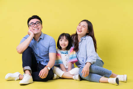 Portrait of young Asian family on backgroundの写真素材