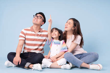 Portrait of young Asian family on background